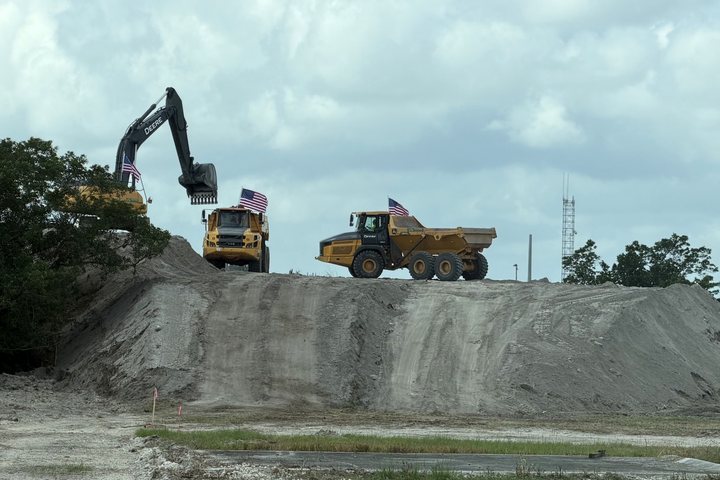 Deere haul trucks on site